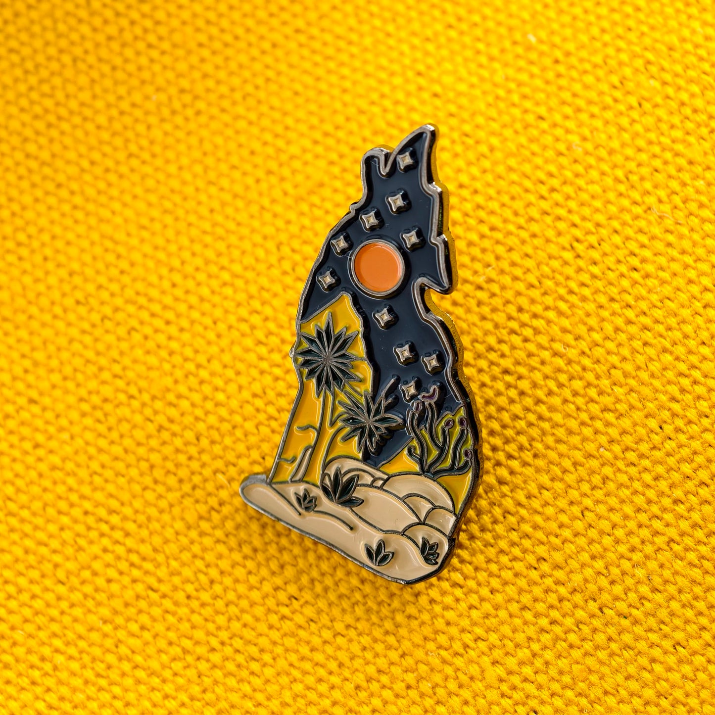 front view of Sunset Wolf Landscape Art Novelty Pin